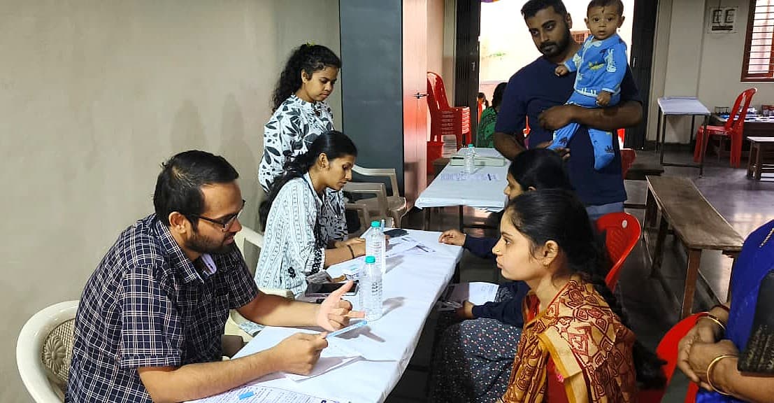 Volunteers registering a family at a health camp