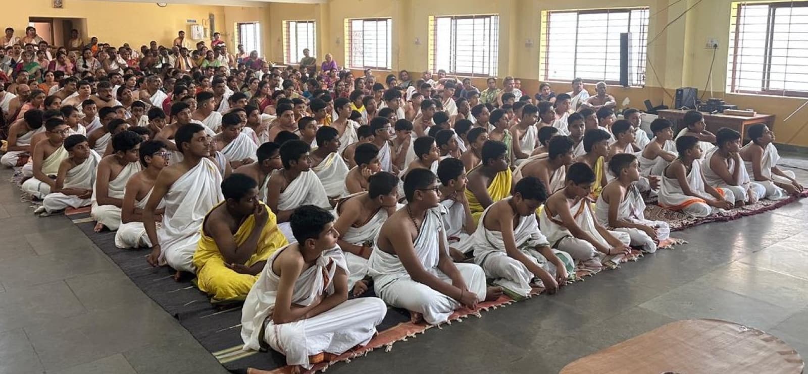 Vatu Sikshana students seated on the floor during a session